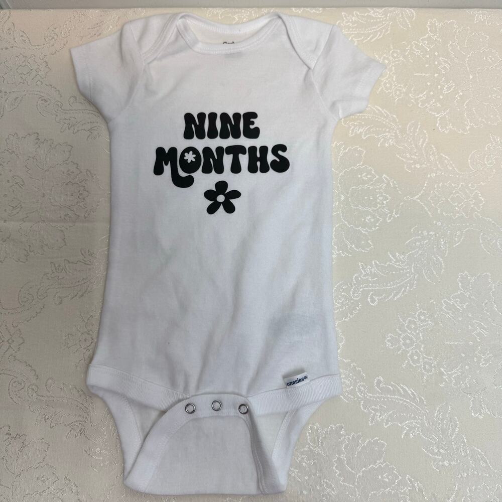 Gerber White Baby Onesie Size 6-9 months "9 Months" with Flower Graphic